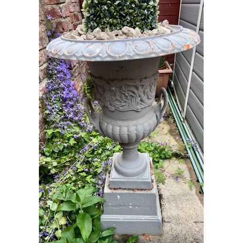 17 - Four cast iron urns on plinths. 85cm h x 46cm d to top.