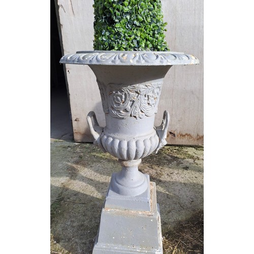 17 - Four cast iron urns on plinths. 85cm h x 46cm d to top.