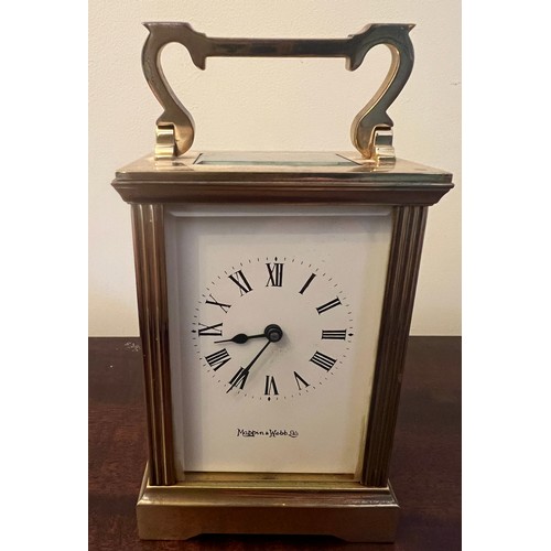 987 - A brass cased carriage clock with visible escapement marked Mappin & Webb to face. 11cm h.