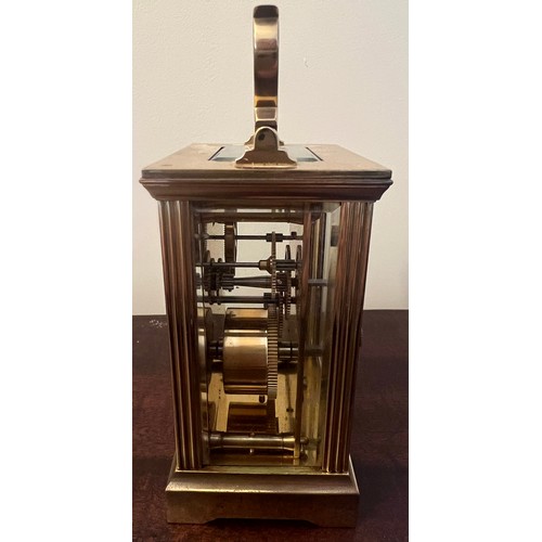 987 - A brass cased carriage clock with visible escapement marked Mappin & Webb to face. 11cm h.