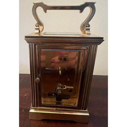 987 - A brass cased carriage clock with visible escapement marked Mappin & Webb to face. 11cm h.