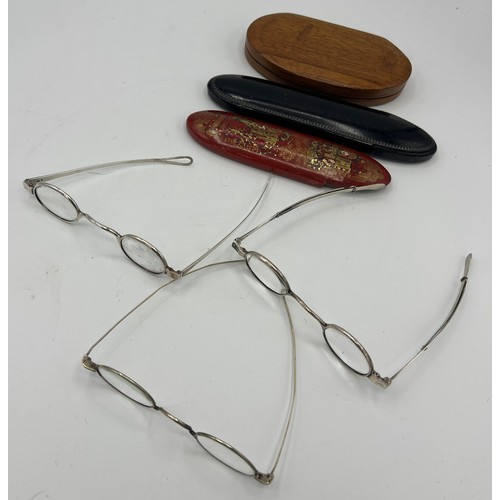 1279 - Three pairs of 19thC spectacles, including two London silver, makers ET and JM, two papier mâché cas... 