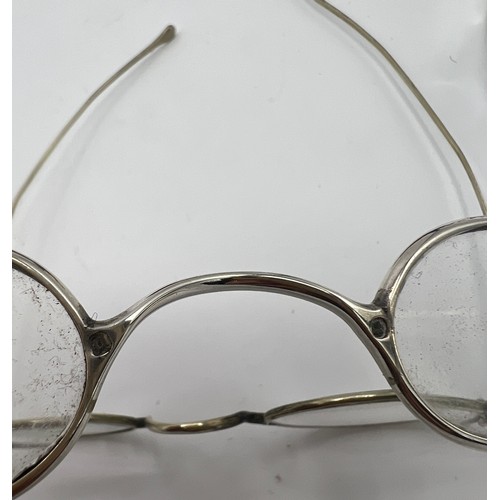 1279 - Three pairs of 19thC spectacles, including two London silver, makers ET and JM, two papier mâché cas... 