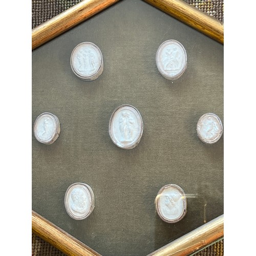 1277 - Seven 18thC century grand tour plaster intaglios contained within a glazed frame. Frame size 26cm x ... 