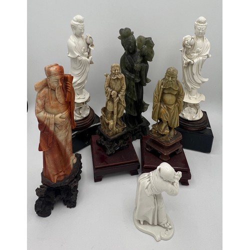 941 - Seven Oriental figures in soapstone, jadeite and Blanc de Chine. Tallest 27cm h.