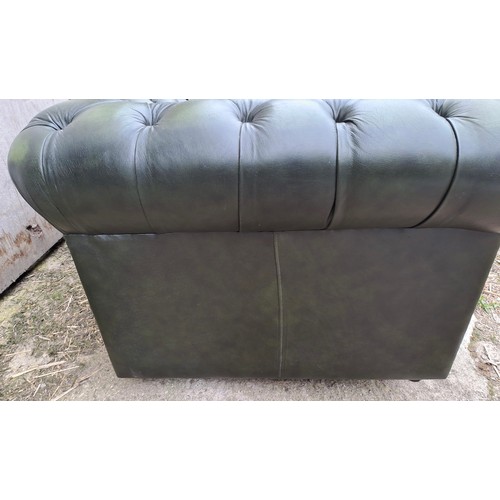 64 - A green leather two seater sofa, 70cm h x 158cm w x 90cm d.