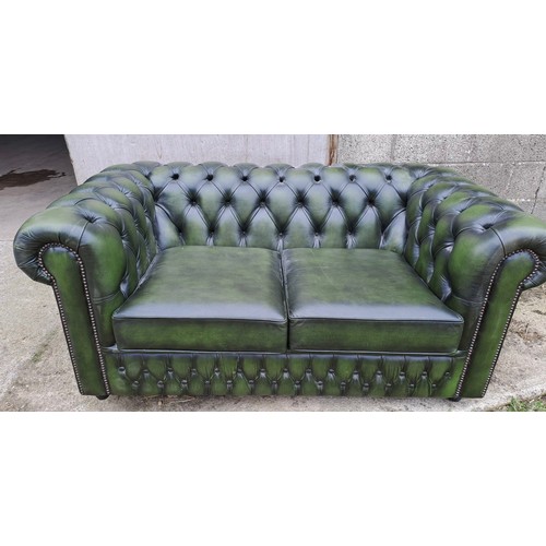 64 - A green leather two seater sofa, 70cm h x 158cm w x 90cm d.