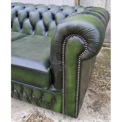 64 - A green leather two seater sofa, 70cm h x 158cm w x 90cm d.