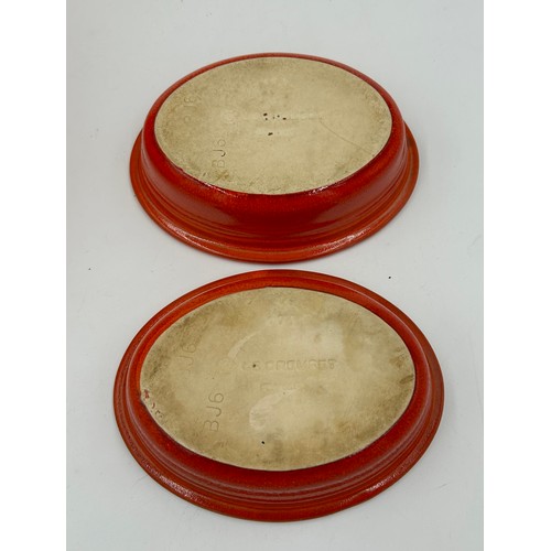 955 - A quantity of Le Creuset volcanic orange to include : three lidded enamelled pans, 22cm, 18cm and 16... 