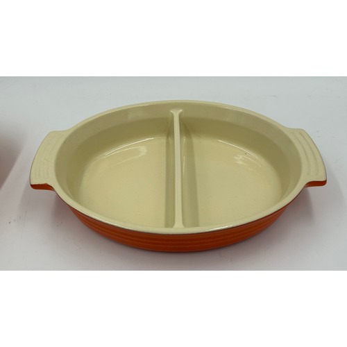 955 - A quantity of Le Creuset volcanic orange to include : three lidded enamelled pans, 22cm, 18cm and 16... 