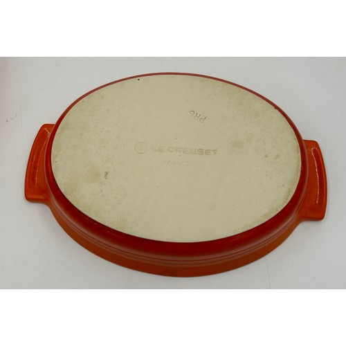 955 - A quantity of Le Creuset volcanic orange to include : three lidded enamelled pans, 22cm, 18cm and 16... 