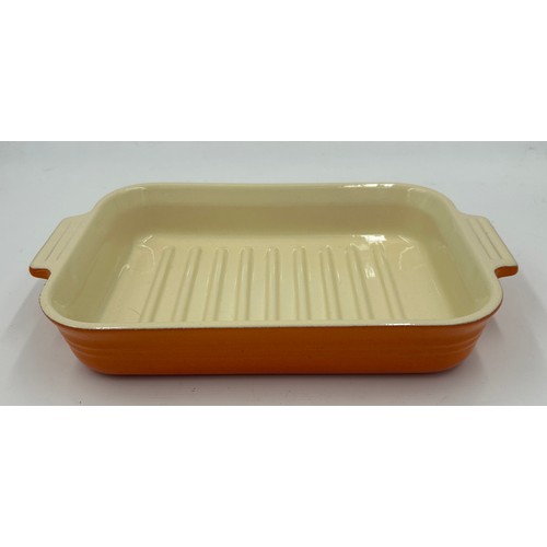 955 - A quantity of Le Creuset volcanic orange to include : three lidded enamelled pans, 22cm, 18cm and 16... 