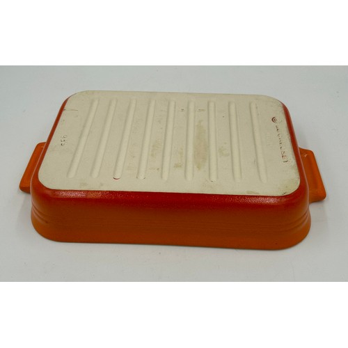 955 - A quantity of Le Creuset volcanic orange to include : three lidded enamelled pans, 22cm, 18cm and 16... 