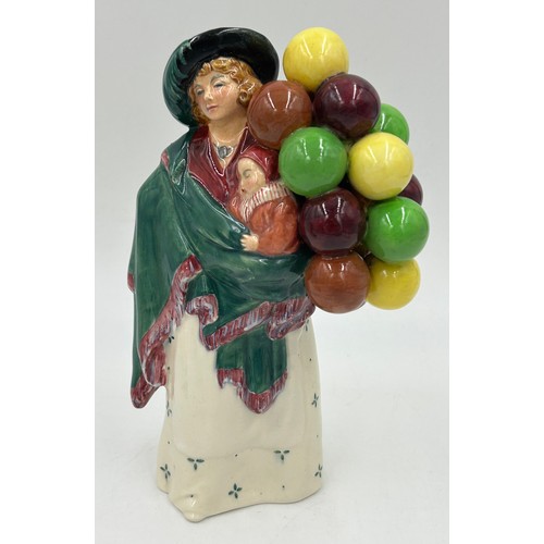 243 - Royal Doulton figurines to include: The Balloon Seller HN583 23cm h, Forty winks HN1974 17cm h, Carr... 