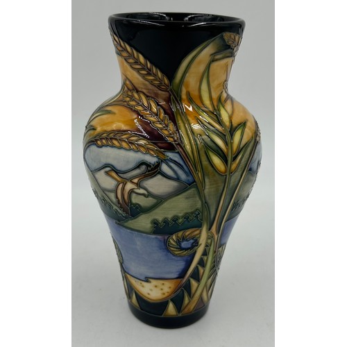 245 - A Moorcroft vase of tapering form, decorated with ears of wheat and reserve panels of birds of prey ... 