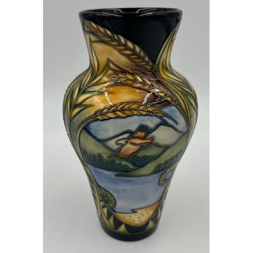 245 - A Moorcroft vase of tapering form, decorated with ears of wheat and reserve panels of birds of prey ... 