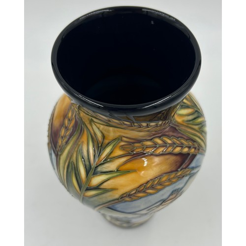 245 - A Moorcroft vase of tapering form, decorated with ears of wheat and reserve panels of birds of prey ... 