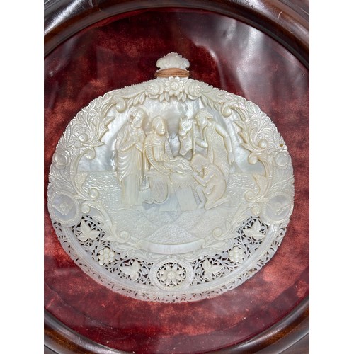 1286 - A Mother of Pearl carved nativity scene from Jerusalem in a mahogany circular glazed frame with a re... 