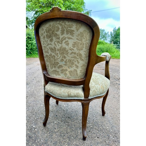 65 - Two upholstered open armchairs/fauteuils in the French style with cabriole legs to front and floral ... 