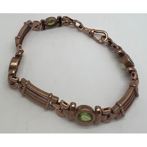 690 - A nine carat gold bracelet set with peridots. Length 19cm. Weight 16.1gm.