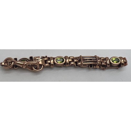 690 - A nine carat gold bracelet set with peridots. Length 19cm. Weight 16.1gm.