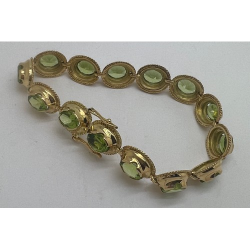 691 - A 18 carat gold bracelet with peridots. Weight 25.3gm.