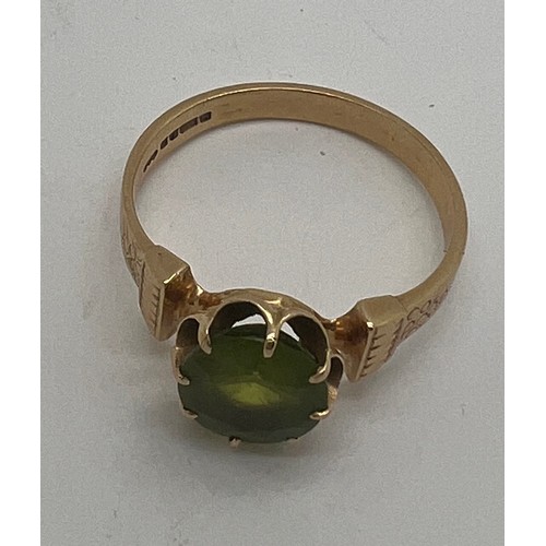 693 - A 14 carat gold ring set with peridot. Size Q. Weight 4.2gm.