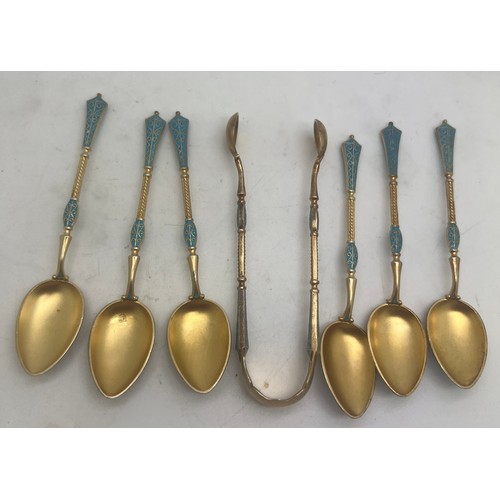 754 - Norwegian white metal and gilt enamel spoons and tongs. Weight 66gm.