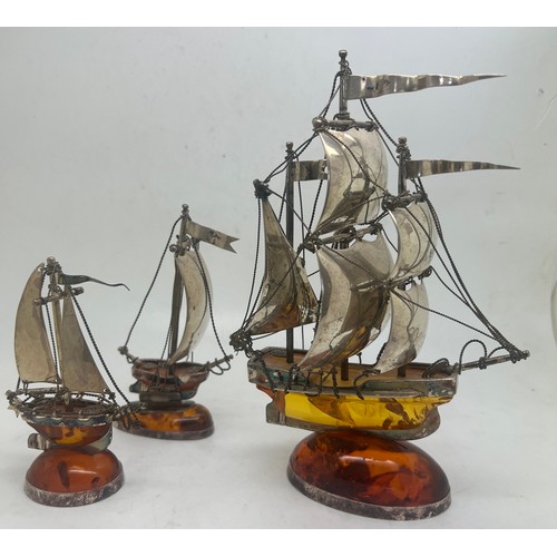 755 - Three silver and amber sailing ships. All marked .925. Largest marked London 2000.