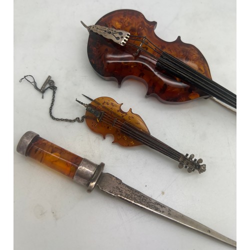 756 - Amber and .925 silver violin and cello with a .925 silver and amber paper knife, 13.5cm l.