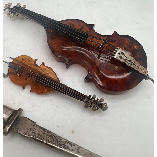 756 - Amber and .925 silver violin and cello with a .925 silver and amber paper knife, 13.5cm l.