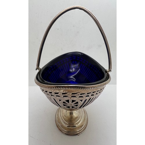 758 - Silver swing handled basket with blue glass liner and fretwork decoration. London 1906, maker Thomas... 