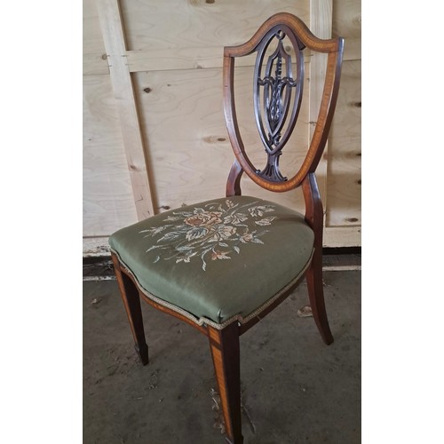 63 - Eight mahogany inlaid shield backed dining chairs. One carver different to others.