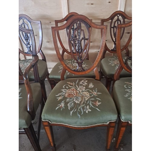 63 - Eight mahogany inlaid shield backed dining chairs. One carver different to others.