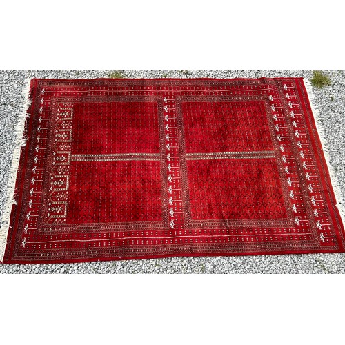 1221 - A large red Kashmir wool carpet. Approx. 179 x 280cm.