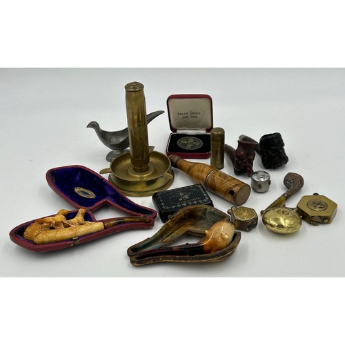 1292 - A miscellany to include trench art lighters, pipes to include a 'real meerschaum' pipe modelled into... 