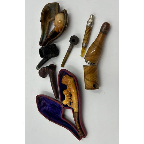 1292 - A miscellany to include trench art lighters, pipes to include a 'real meerschaum' pipe modelled into... 