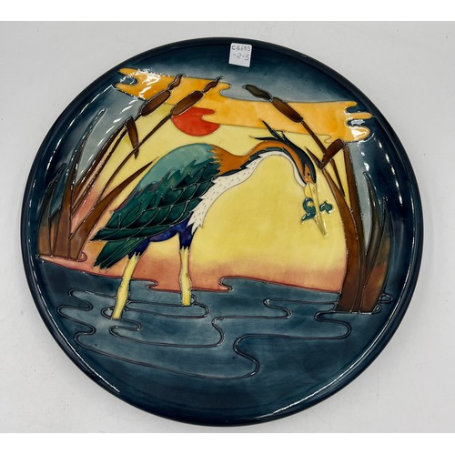 213 - A Moorcroft charger depicting a heron amongst bullrushes. 35cm d.