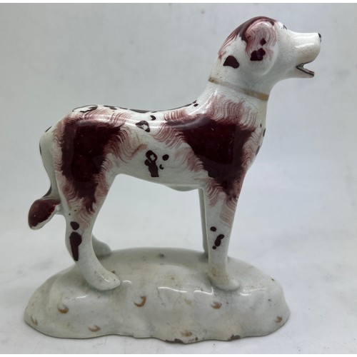 216 - A Staffordshire figure in the style of Rockingham, of a standing dog with open mouth and red tongue.... 