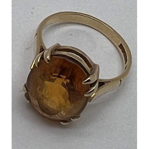 675 - A 9 carat gold ring set with single amber coloured stone, size  M, weight 3.9gm.