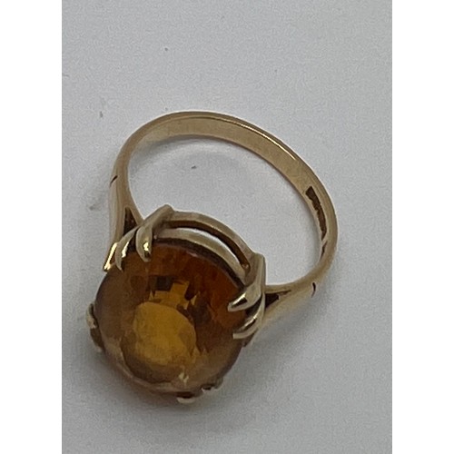 675 - A 9 carat gold ring set with single amber coloured stone, size  M, weight 3.9gm.