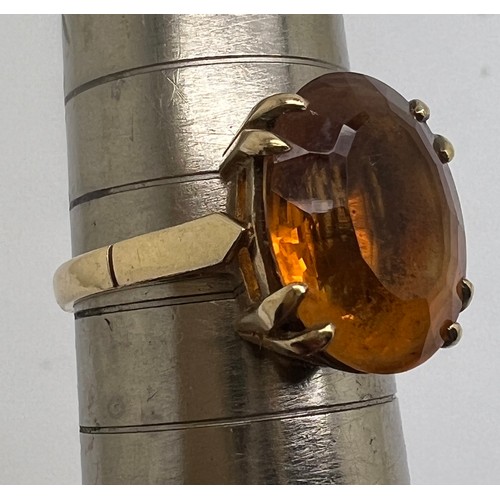 675 - A 9 carat gold ring set with single amber coloured stone, size  M, weight 3.9gm.