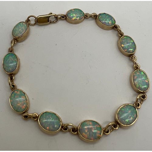 629 - A 9 carat gold and opal bracelet. Weight 8.8gm. 17cm l.