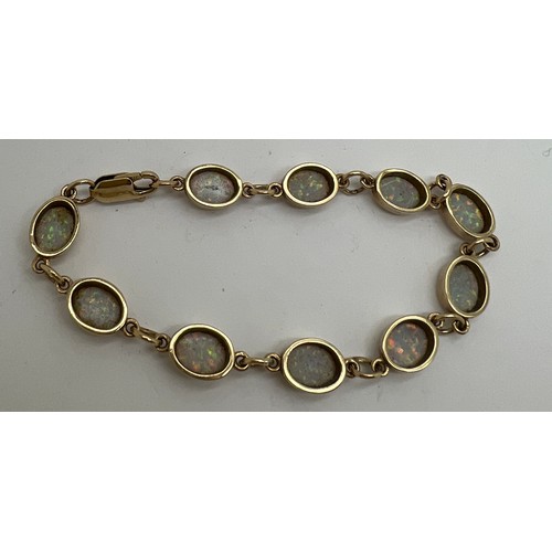 629 - A 9 carat gold and opal bracelet. Weight 8.8gm. 17cm l.