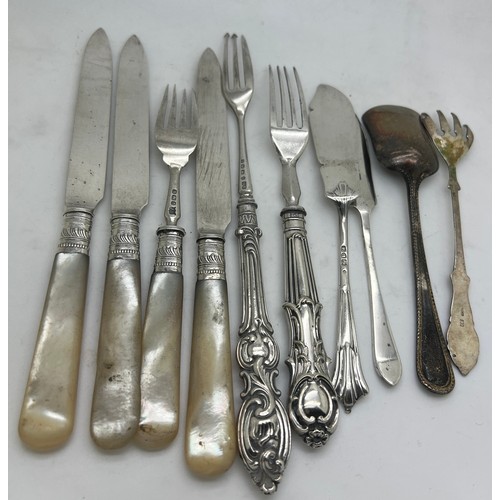 786 - A quantity of silver cutlery to include three knives and one fork with mother of pearl handles, butt... 