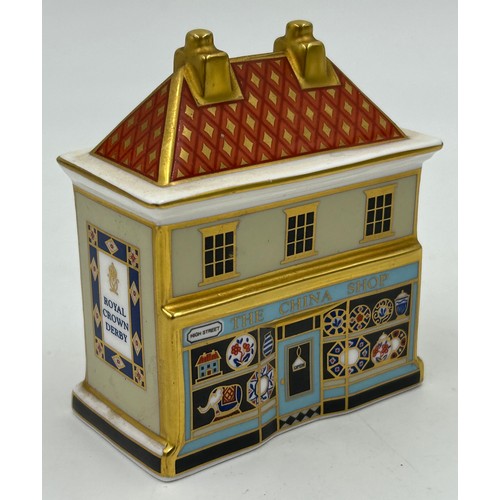 400 - A collection of Royal Crown Derby Cottages to include 'The Christmas Box' 'The China Shop' signed to... 