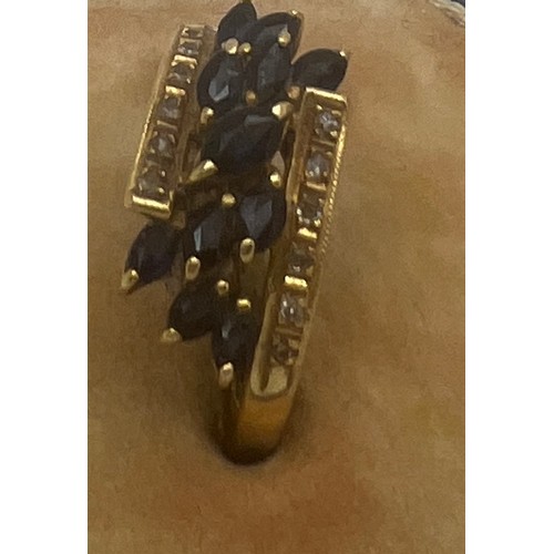 636 - An 18 carat gold ring set with sapphires and diamonds. Size N. Weight 3.2gm.