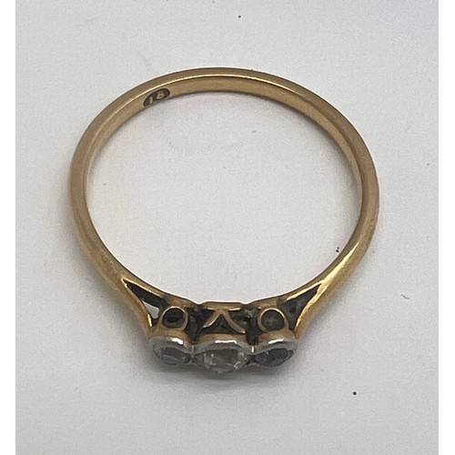 654 - An eighteen carat gold ring set with three old cut diamonds. Size L. Weight 1.5gm.