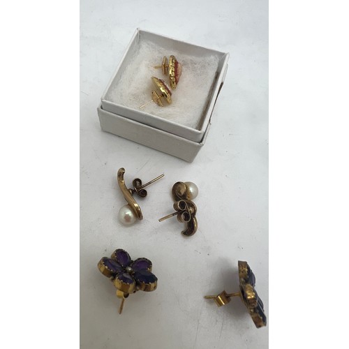 659 - Three pairs of earrings to include 9 carat gold set with cultured pearl, cameo and purple stone and ... 