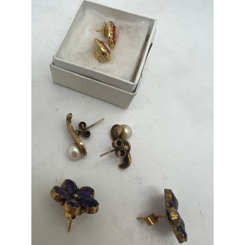 659 - Three pairs of earrings to include 9 carat gold set with cultured pearl, cameo and purple stone and ... 